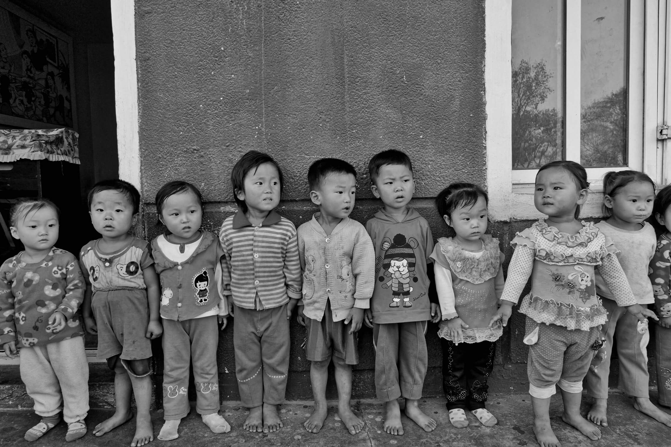 North Korean children singing outside nursery home